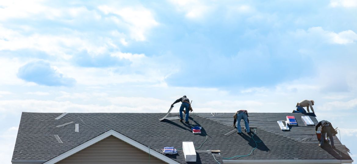 4 construction workers fixing roof against clouds blue sky, inst