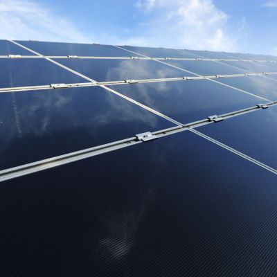 Alternative energy photovoltaic solar panels against blue sky